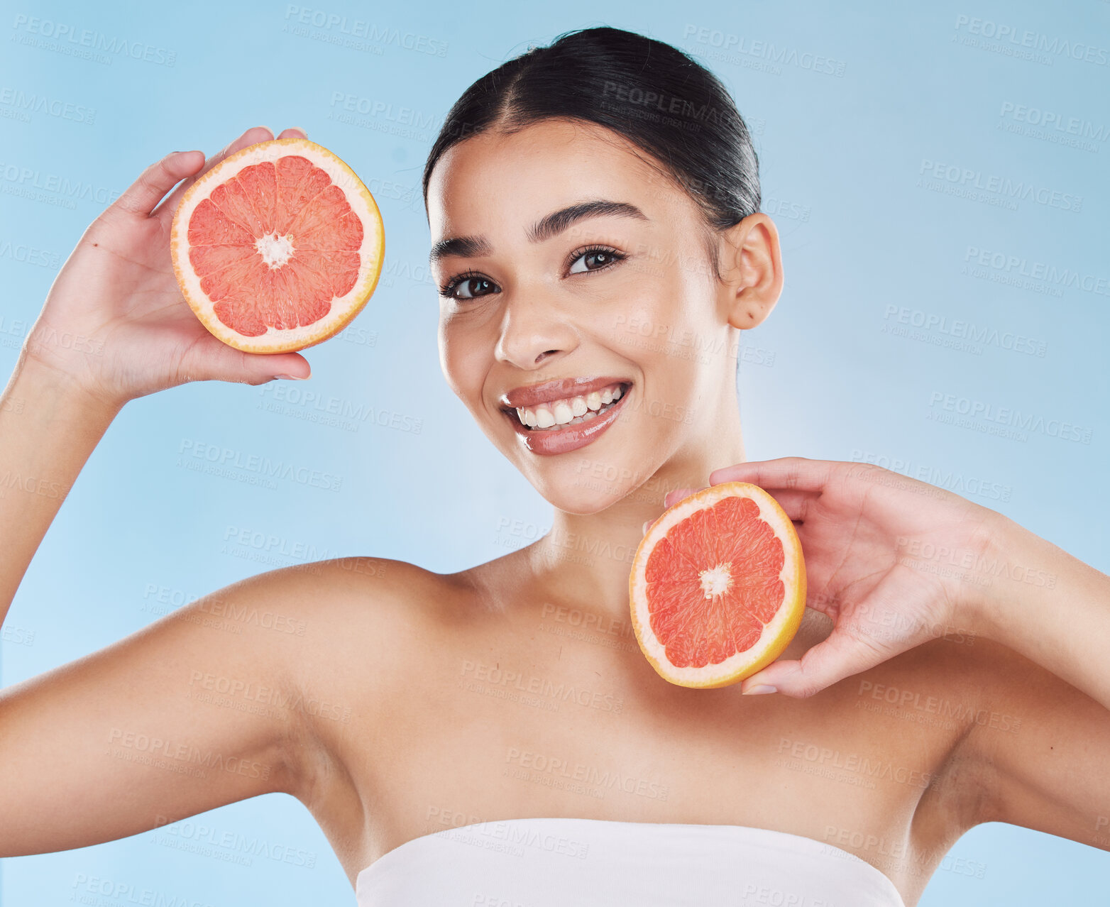 Buy stock photo Grapefruit, skincare, face and diet wellness keeps her happy and healthy for skin healthcare, eat healthy fruit with nutrition. Portrait of a beauty woman in studio against a blue background