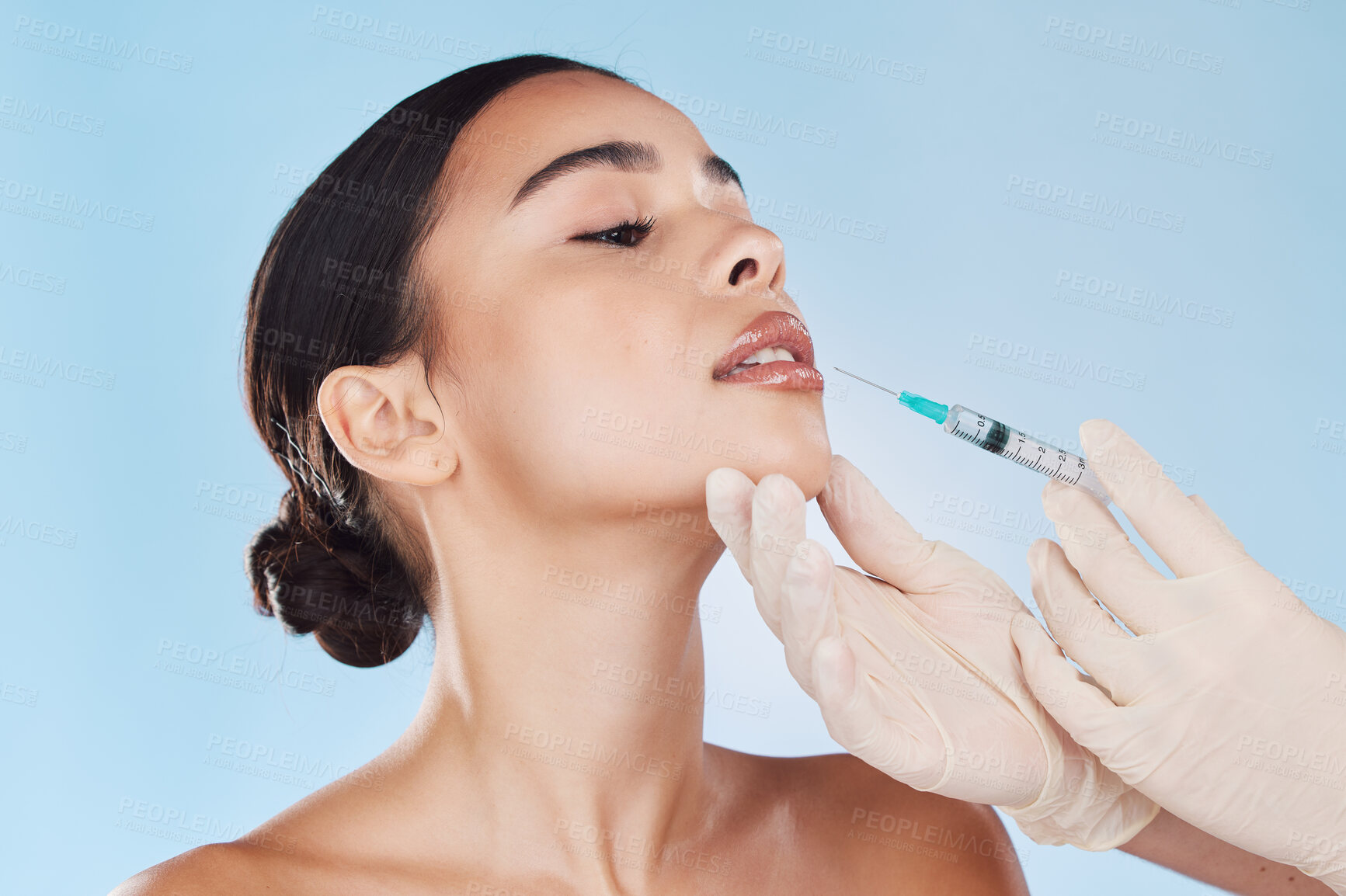 Buy stock photo Plastic surgery, collagen and lip filler for beauty aesthetic goal, youth and young face or facial appearance. Cosmetic surgery doctor hands work on woman, patient or client lips with blue background