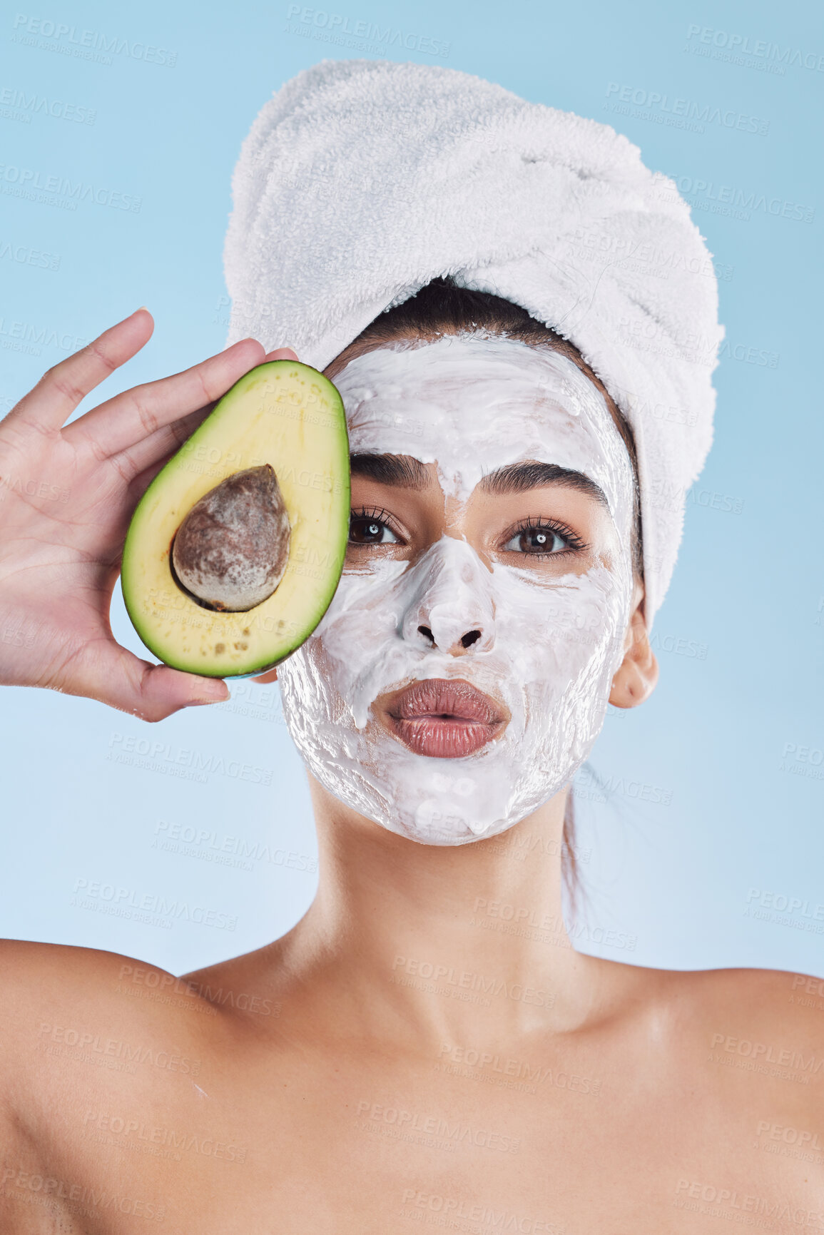 Buy stock photo Avocado, woman skincare or face mask with fruit in wellness grooming, health or product facial on blue background. Zoom on beauty studio model portrait, food in hands or hair care towel for self care