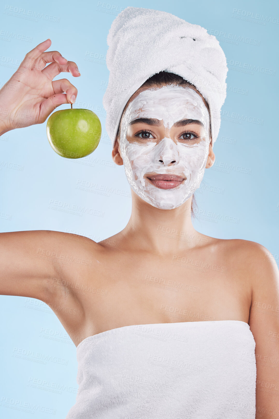 Buy stock photo Woman, skincare and apple face mask, organic beauty and wellness for healthy face, fresh facial and natural clean glowing skin on studio blue background. Portrait, shower and model grooming bodycare