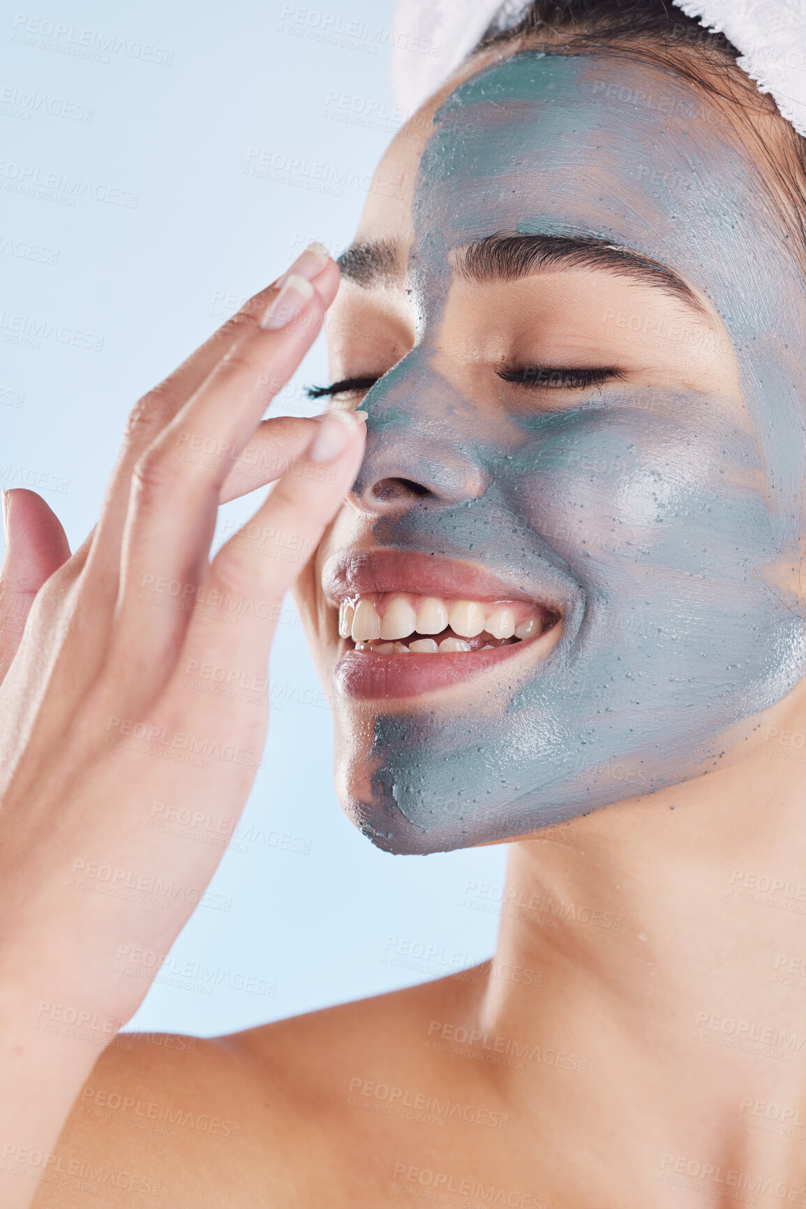 Buy stock photo Charcoal face mask for beauty skincare, natural product for healthy skin and clean cosmetic wellness for body against blue mockup studio background. Happy, smile and healthcare on woman model