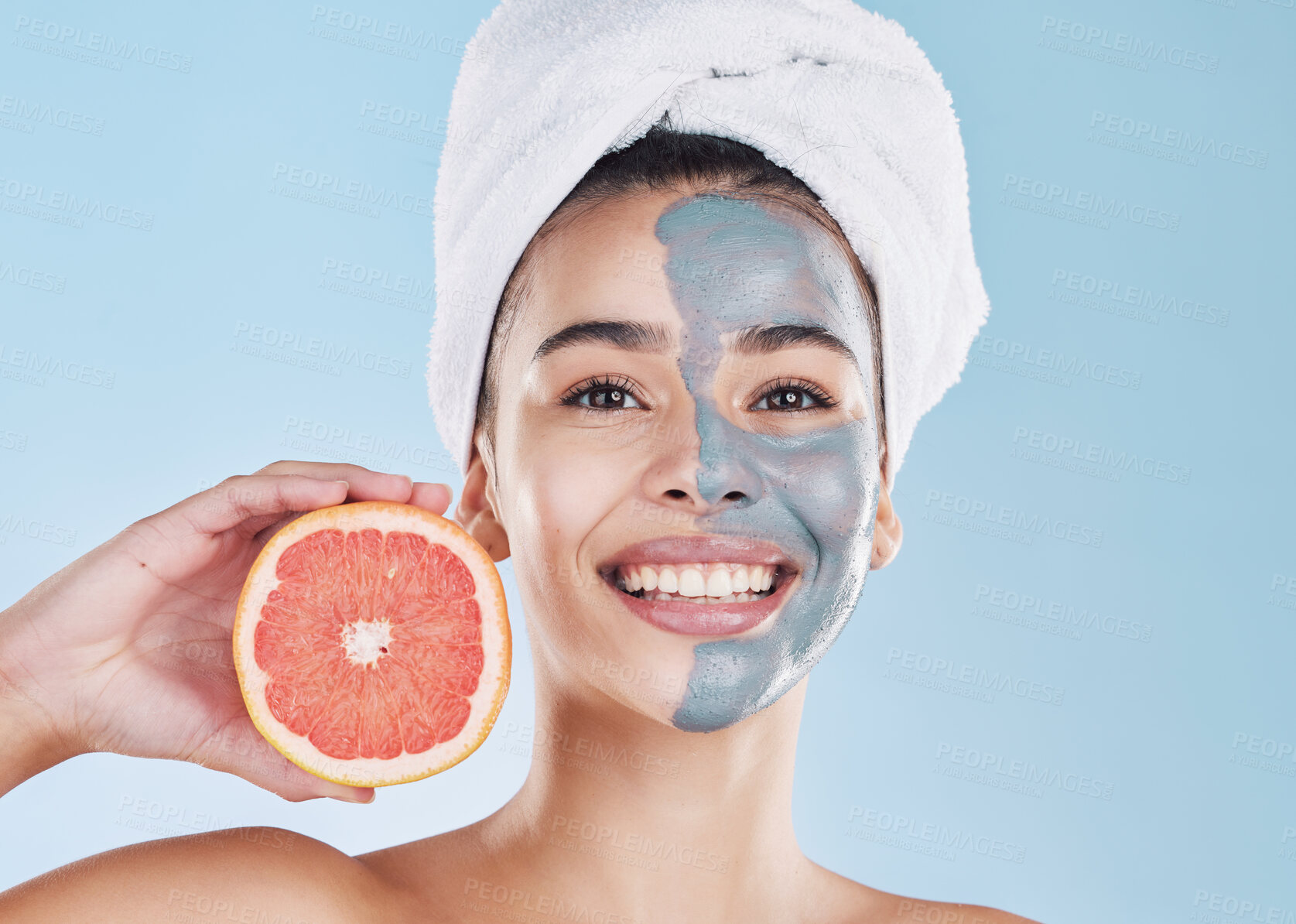 Buy stock photo Woman, skincare and grapefruit face mask, organic beauty and wellness for healthy face, fresh facial and natural clean glowing skin on blue background. Portrait, smile and model grooming bodycare