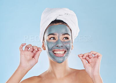 Buy stock photo Skincare mask, hair care or dental floss in grooming, busy beauty and studio wellness on blue background. Smile, happy face or relax woman with mud product facial and cleaning teeth for healthy gums