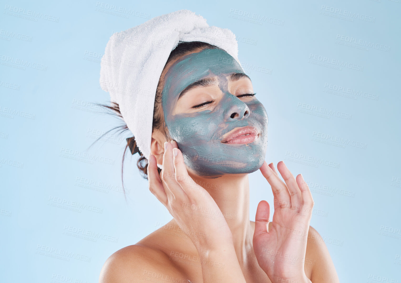 Buy stock photo Skincare, body wellness and charcoal face mask for healthy woman skin against blue mockup studio background. Young, happy and beauty cosmetic model with antiaging product for wellbeing and grooming