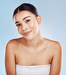 Closeup face beautiful young mixed race woman. An attractive female posing in studio isolated against a blue background. A skincare regime that keeps your skin soft, smooth, glowing and healthy