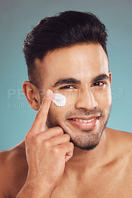 Buy stock photo Portrait, skincare and lotion with a man in studio on a gray background to apply antiaging facial treatment. Face, beauty and cream with a young male person indoor for wellness or aesthetic self care
