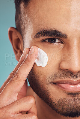Buy stock photo Portrait, facial and lotion with a man in studio on a gray background to apply antiaging skincare treatment. Face, beauty or cream with a young male person applying spf sunscreen indoor for self care