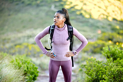 Buy stock photo Black woman, hiking and thinking outdoor in nature with a backpack for adventure, fitness and breathing. Tired african person with hands on hips for break from mountain climbing, exercise or trekking