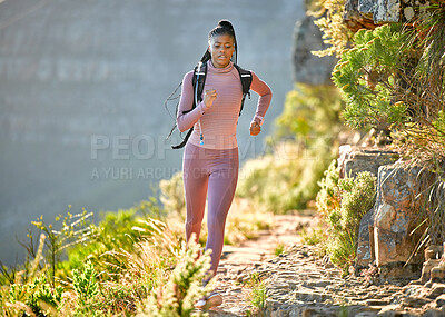Buy stock photo Black woman, mountain running and outdoor for fitness, speed or challenge for wellness with focus in summer. African girl, workout and runner training in sunshine with exercise, adventure and hiking