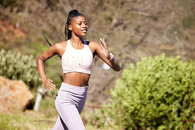 Buy stock photo Black woman, mountain running and nature for fitness, speed or challenge for wellness with focus in summer. African girl, workout and runner training in sunshine with exercise, adventure and hiking