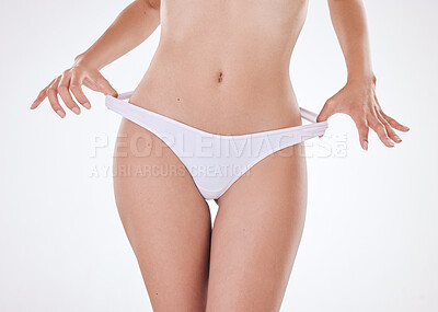 Closeup of unrecognizable mixed race model's hairless body and slim waist posing against a white copyspace background. Unknown Hispanic woman feeling positive after weight loss
