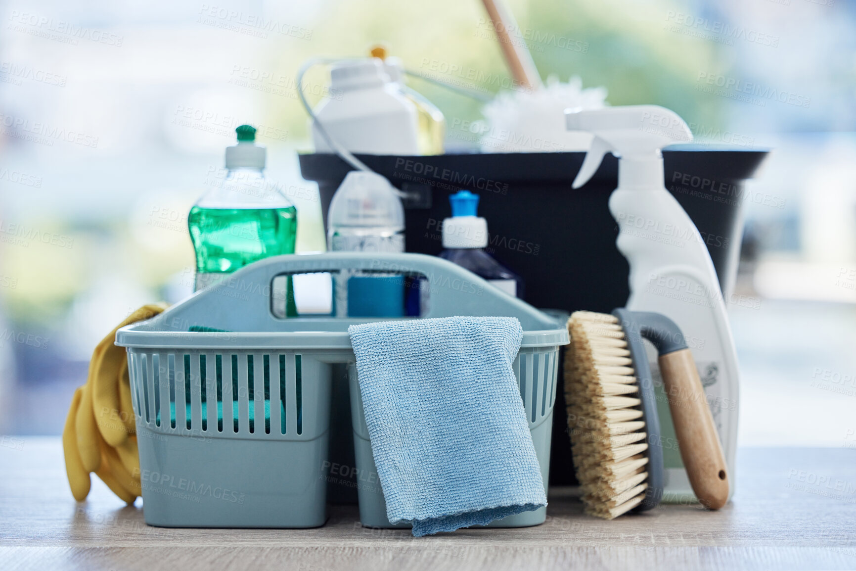 Buy stock photo Basket, table and product for cleaning home with brush, cloth and chemical for hygiene by blurred background. Empty house, desk and plastic container for services, stop bacteria and dust in interior