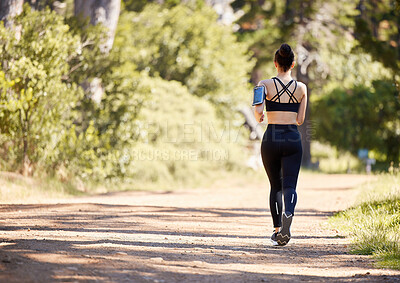 One active young mixed race woman from the back running outdoors. Female athlete doing cardio workout while exercising for better health and fitness