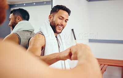 Buy stock photo Cheerful friends gving each other a fist bump. Two players bonding and celebrating with a fist bump.Active men relaxing together in a locker room. Two men taking a break before training