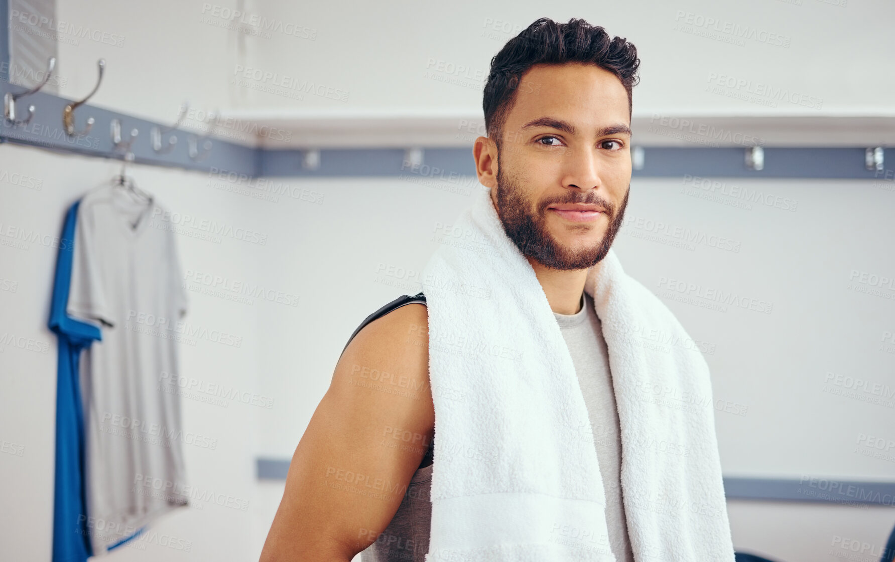 Buy stock photo Portrait of a handsome mixed race athlete. Fit young man resting in his gym locker room. Young man taking a break from a squash match to relax in his gym locker room. Happy player in his gym