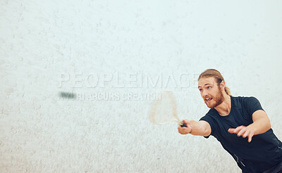 Buy stock photo Athletic young squash player hitting the ball during a game on the court with copyspace. Fit active caucasian male athlete training and playing in a sports centre alone. Healthy cardio and motion blur