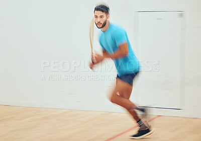 Buy stock photo Young athletic squash player running while playing court game with copyspace and motion blur. Fit mixed race athlete moving with speed during training practice in sports centre. Sporty hispanic man