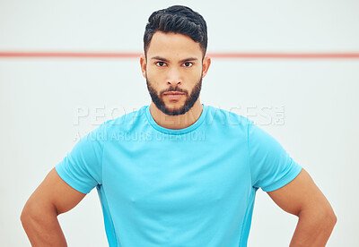 Buy stock photo Portrait of squash player looking focused before playing a game on court with copyspace. Fit active hispanic athlete standing alone before training practice in sports centre. Young sporty athletic man