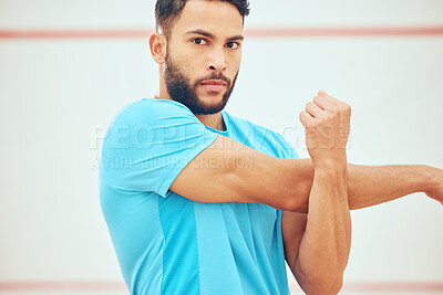 Buy stock photo Portrait of mixed race squash player stretching and looking focused before playing a game on court. Fit active hispanic athlete standing alone and getting ready for training practice in sports centre