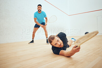 Buy stock photo Two athletic squash players playing match during competitive court game. Fit active mixed race and caucasian athlete competing during training challenge in sports centre. Sporty men in championship