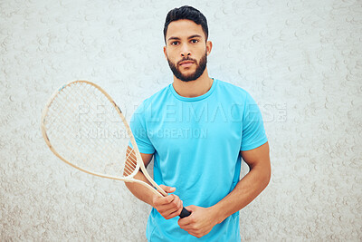 Buy stock photo Portrait of squash player holding racket before playing court game with copyspace. Serious, focused fit active hispanic athlete standing alone and getting ready for training practice in sports centre