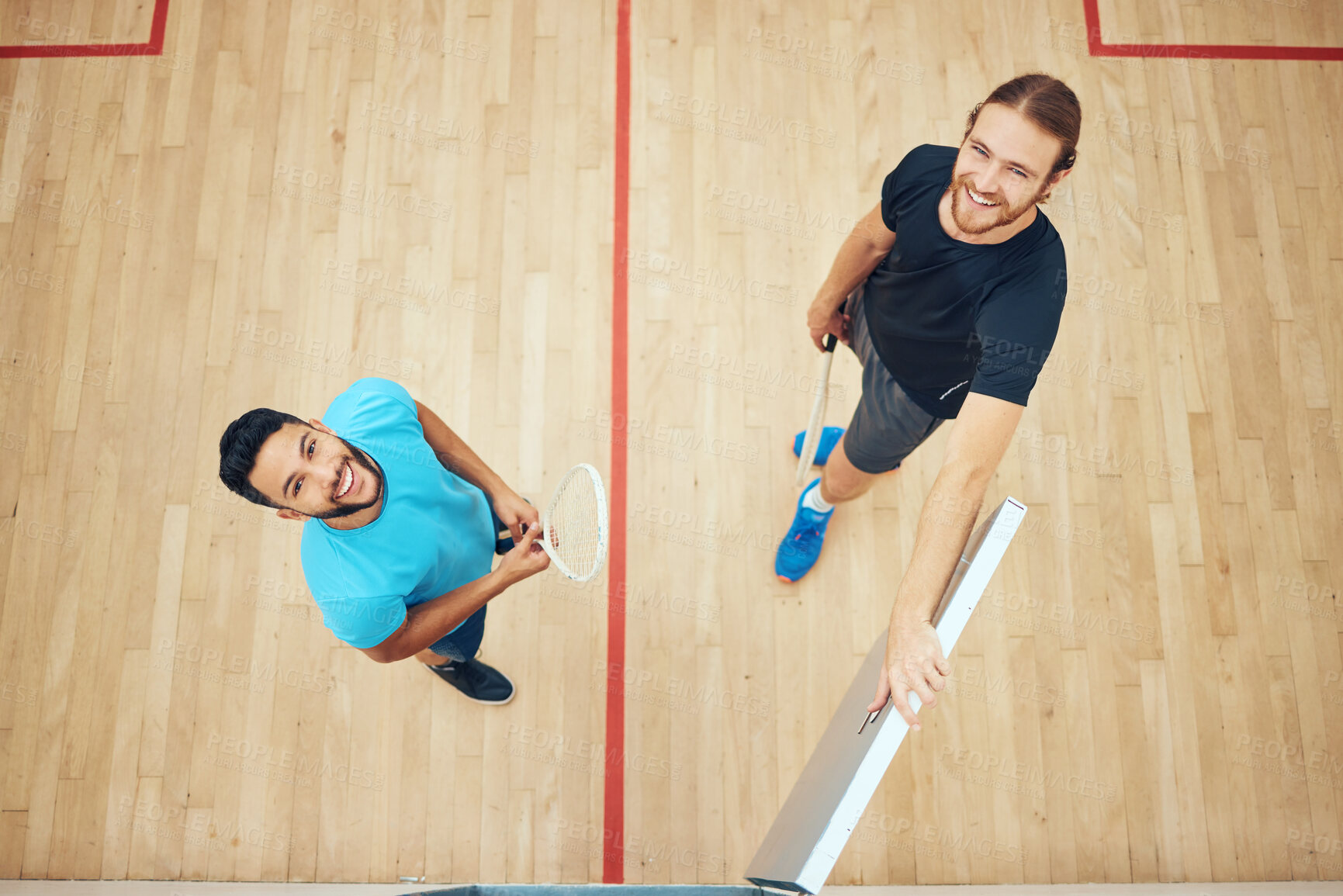 Buy stock photo Above portrait of two athletic squash players standing together after playing court game. Fit active mixed race and caucasian athletes after practice and training in sports centre. Team of sporty men