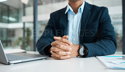 Buy stock photo Businessman working on a laptop alone at work. One content businessperson looking ready while sitting at a desk in an office