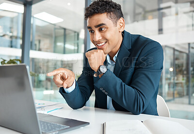 Buy stock photo Young happy mixed race businessman pointing a finger while working on a laptop alone at work. Hispanic male businessperson smiling and reading an email on a laptop while pointing a finger working in an office