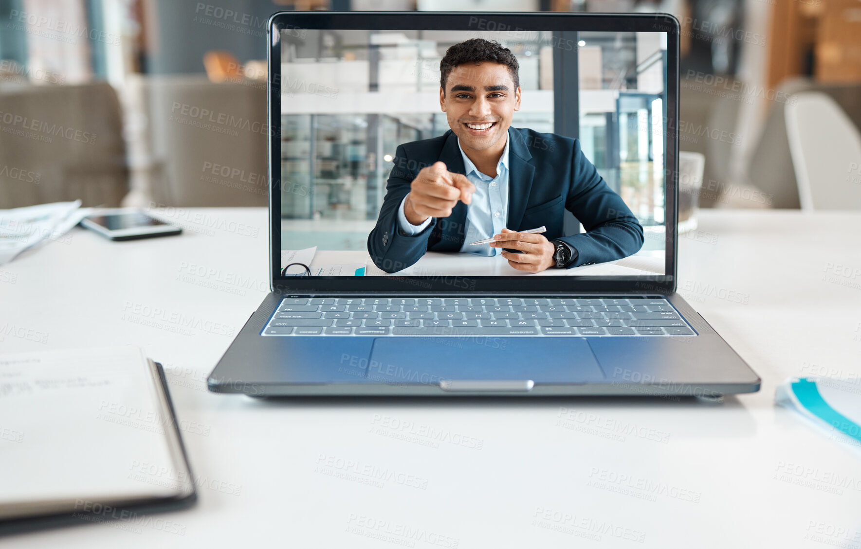 Buy stock photo Happy mixed race businessman pointing his finger on a video call using a laptop alone at work. One hispanic businessperson smiling on a virtual call in an office