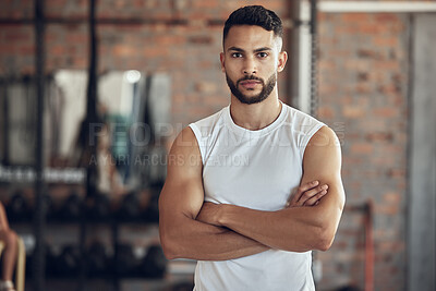 Buy stock photo Portrait of bodybuilder with attitude in the gym. Young bodybuilder with arms crossed in the gym. Cool, fit man standing in the gym. Healthy athlete taking a break from training in the gym