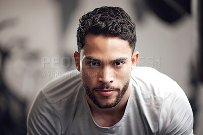Buy stock photo Portrait of one serious young hispanic man focused on his exercising session in a gym. Determined mixed race guy getting mentally prepared to stay motivated and dedicated during a training workout in a fitness centre