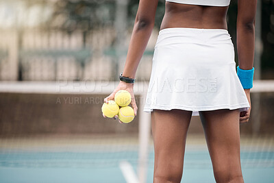 Buy stock photo Closeup on the hands of a tennis player holding tennis balls. Tennis player standing on the court at the club. Tennis player ready for practice. Back of tennis player ready to compete