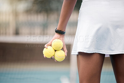 Buy stock photo Behind tennis player standing on the club court. African american woman holding tennis balls ready for a match. Closeup on the hands of a tennis player ready for practice at the club