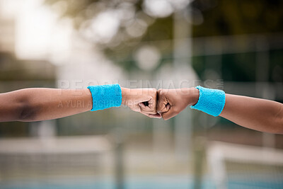 Buy stock photo Closeup on the hands of tennis players on the court. Two tennis players give each other a fist bump. Friends motivate each other on the tennis court. Athletes bonding before tennis practice
