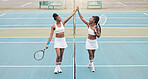 Young girls celebrate after a tennis match. Professional athletes motivate each other with a high five. African american players support each other after tennis practice. Tennis players high five.