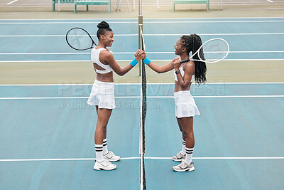 Buy stock photo Cheerful women holding hands over the net on a tennis court. Young women support each other after tennis practice. Friends celebrate each other after a game of tennis. Friends on the tennis court