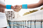 Closeup on hands of tennis players greeting on the court. Hands of a tennis player greeting an opponent. African american professional tennis players collaborate after a tennis game
