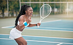 Professional tennis player screaming in excitement after a match. African american woman cheering her success after a game of tennis. Excited tennis player shouting on the court after a match