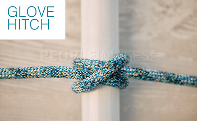 Above shot of hiking rope tied in a knot against a wooden background in studio. Glove hitch knot, A knot for every situation. Strong rope to secure safety while mountain climbing or extreme sports