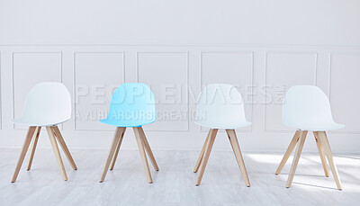 Buy stock photo Four chairs lined up in an office waiting room. One blue chair and three white, waiting for potential job candidates to be seated, interviewed and potentially hired by human resources for a new career