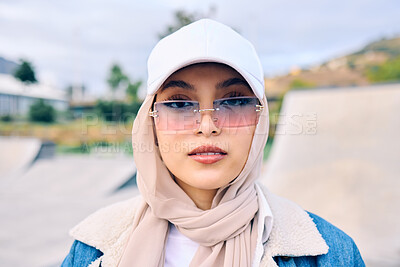 Buy stock photo Portrait, fashion or sunglasses with a muslim woman outdoor in a cap and scarf for contemporary style. Islam, faith and hijab with a trendy young arab female person posing outside in modern eyewear