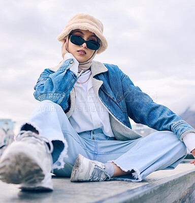 Buy stock photo Portrait, fashion or eyewear with an islamic woman outdoor in a cap and scarf for contemporary style. Muslim, faith or hijab with a trendy young arab female person posing outside in modern sunglasses