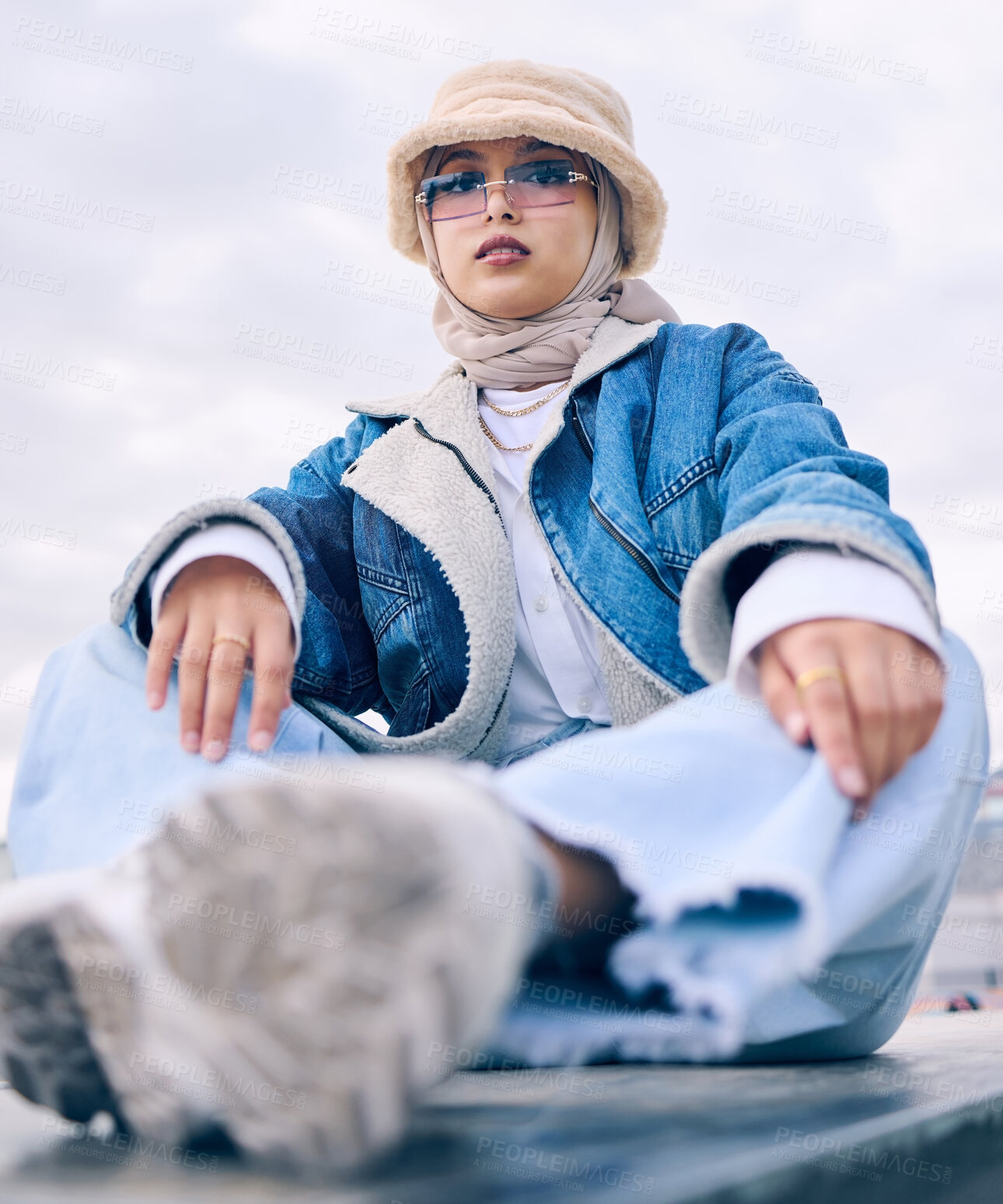 Buy stock photo Portrait, fashion or sunglasses with a muslim woman in the city wearing a cap and scarf for contemporary style. Islam, faith and hijab with a trendy young arab person posing outside in modern eyewear