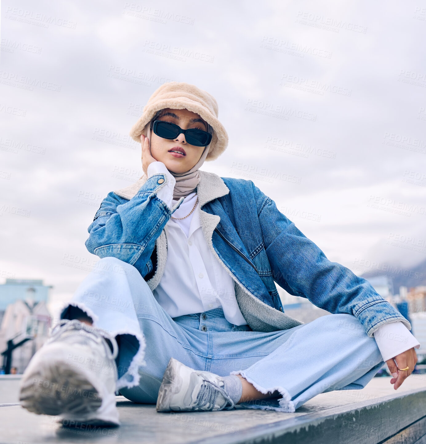 Buy stock photo Portrait, fashion and Islamic woman in a city, sunglasses and trendy with a hijab, stylish outfit or gen z. Face, Muslim female person or confident girl outdoor with casual clothes, beauty or eyewear