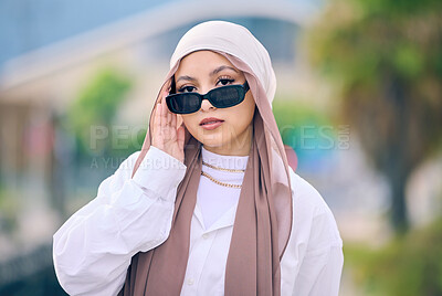Buy stock photo Portrait, fashion or sunglasses with an arabic woman outdoor in a cap and scarf for contemporary style. Islam, faith and hijab with a trendy young muslim person posing outside in modern eyewear