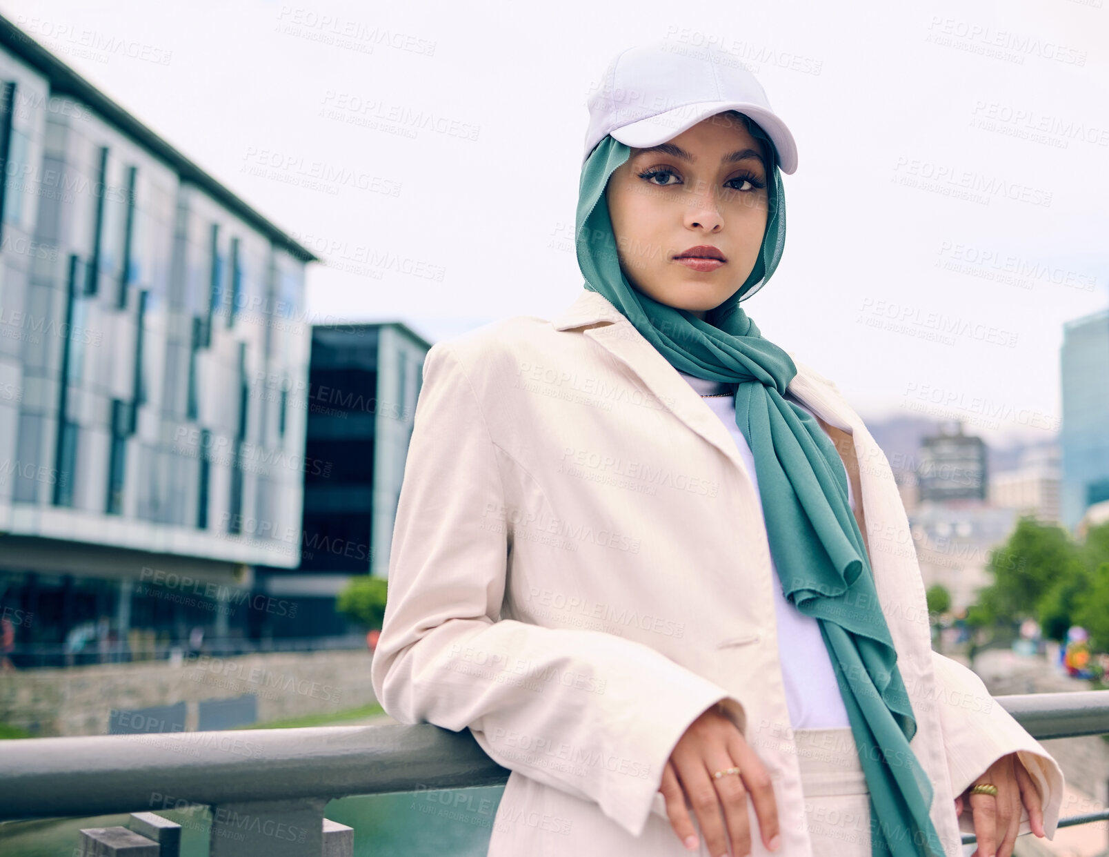 Buy stock photo Portrait, city fashion or religion with an islamic woman outdoor in a cap and scarf for contemporary style. Arabic, faith or hijab with a trendy young muslim person posing outside in urban clothes