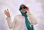 Beautiful young arab woman posing outdoors in a headscarf. Attractive female muslim wearing a hijab posing outside. She's all about style and fashion. Mixed race woman looking confident and trendy