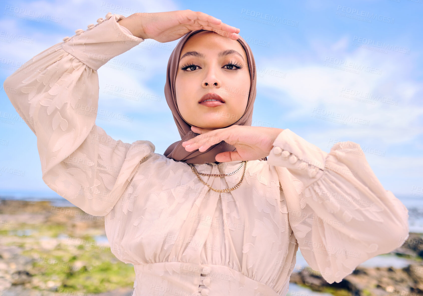 Buy stock photo Portrait, hands or fashion with a muslim woman outdoor in a scarf for religion or contemporary style. Saudi, face and hijab with a trendy young islam female person posing outside in modern clothes