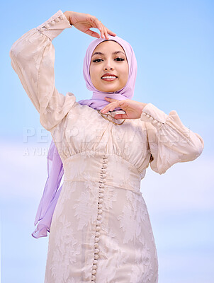 Buy stock photo Portrait, fashion or faith with a happy muslim woman on a blue sky background in a scarf for style. Islam, religion and hijab with a trendy young saudi person posing outside in contemporary clothes