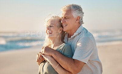 Buy stock photo Happy mature couple bonding on holiday. Mature couple on vacation by the beach together. Mature caucasian couple hugging on the beach. Senior husband hugging his wife by the ocean on vacation